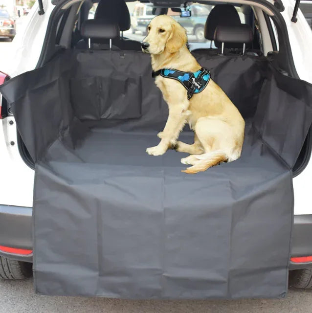 Golden retriever in blue harness sitting on protective SUV cargo liner, outdoor adventure gear