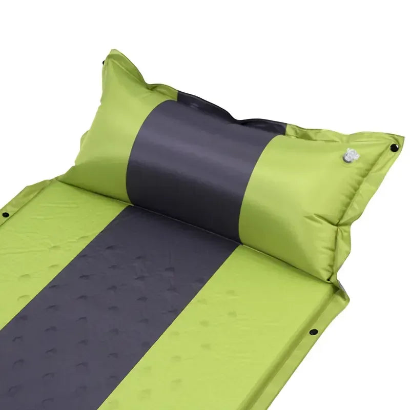 Green and black inflatable camping sleeping pad with built-in pillow, outdoor gear